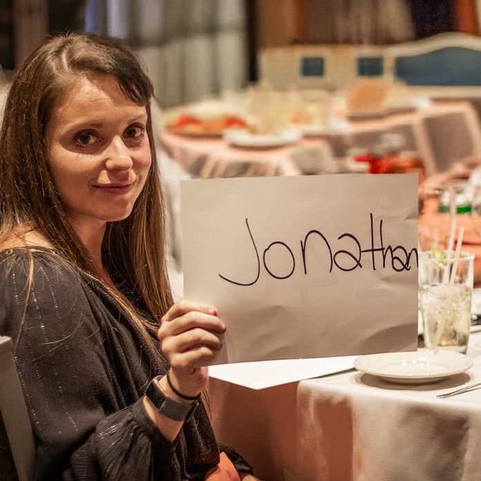 Woman holds a sign reading